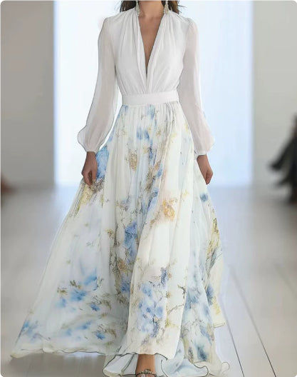 Long floral dress with a white top worn by a person on a blurred background