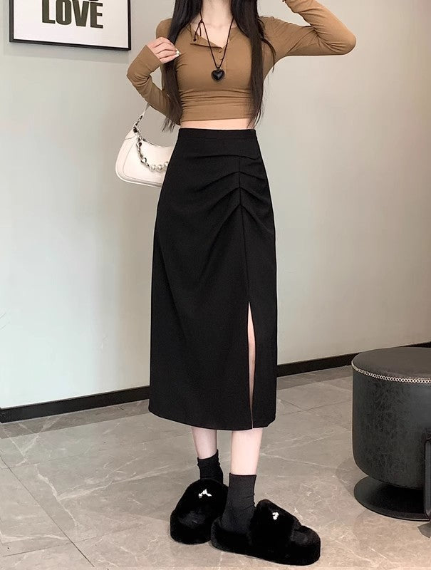 Woman wearing a brown long-sleeve top and black skirt indoors.