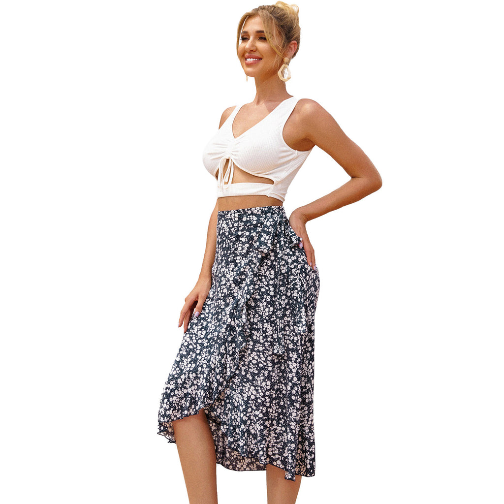 Woman wearing a white top and floral skirt on a white background