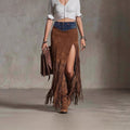 Person wearing a brown suede fringe skirt and boots against a neutral background