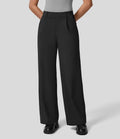 Person wearing black wide-leg pants on a light gray background