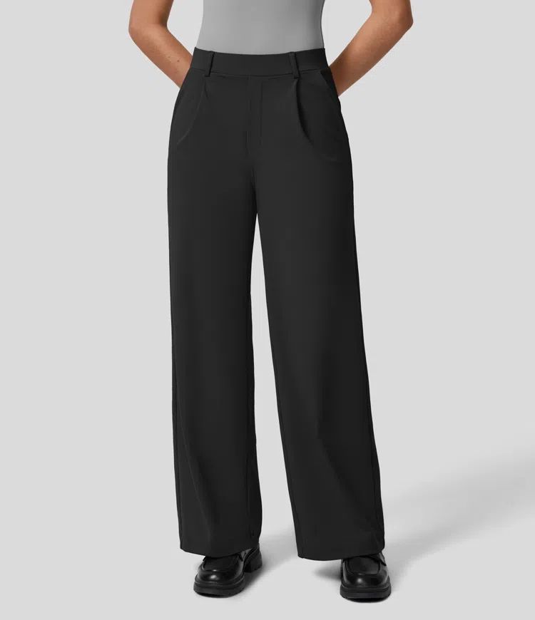 Person wearing black wide-leg pants on a light gray background