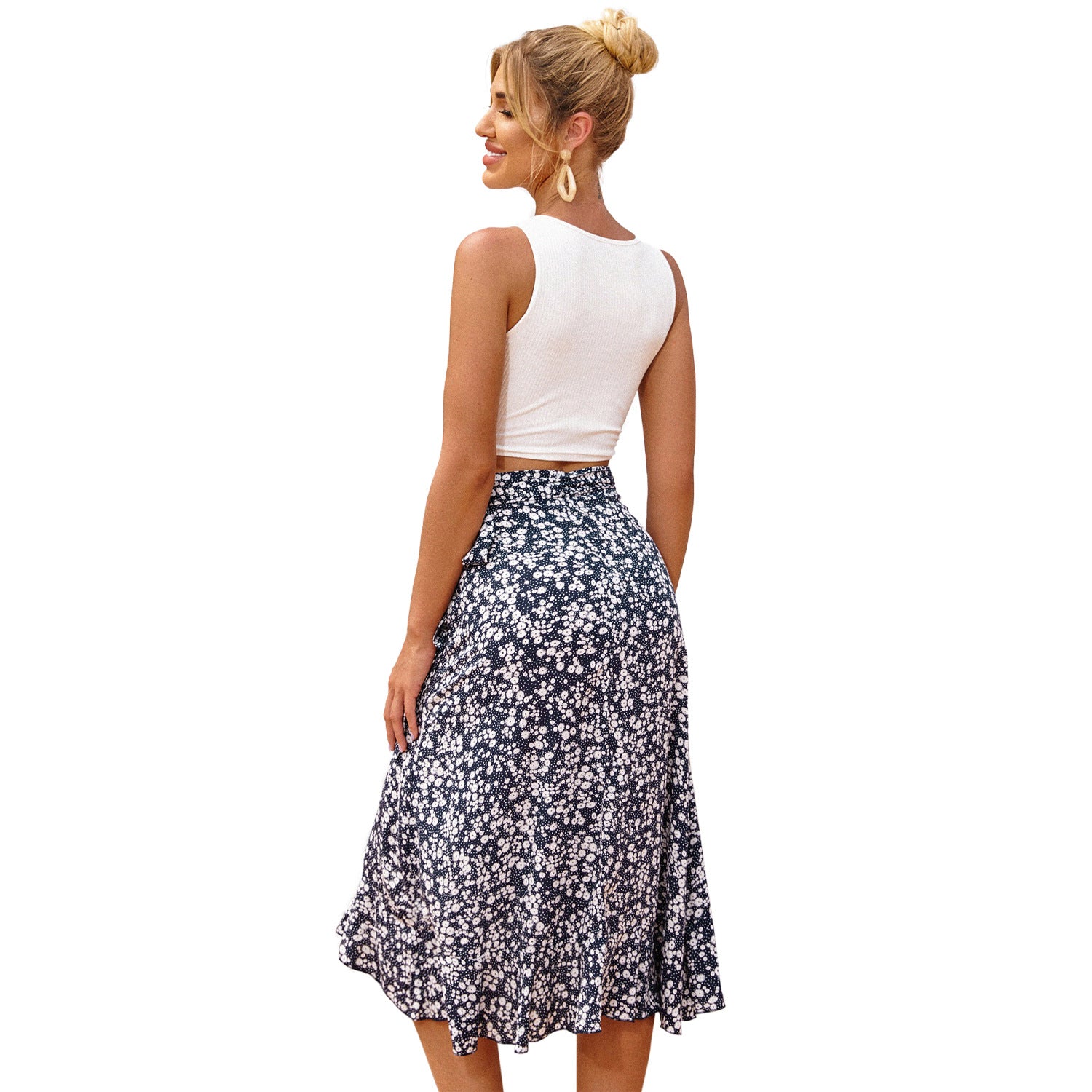 Woman wearing a white top and floral skirt on a white background