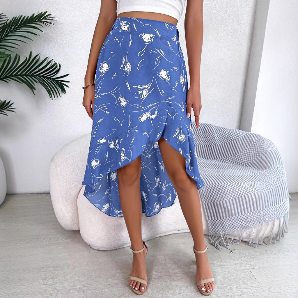 Person wearing a blue patterned skirt in a minimalistic room.