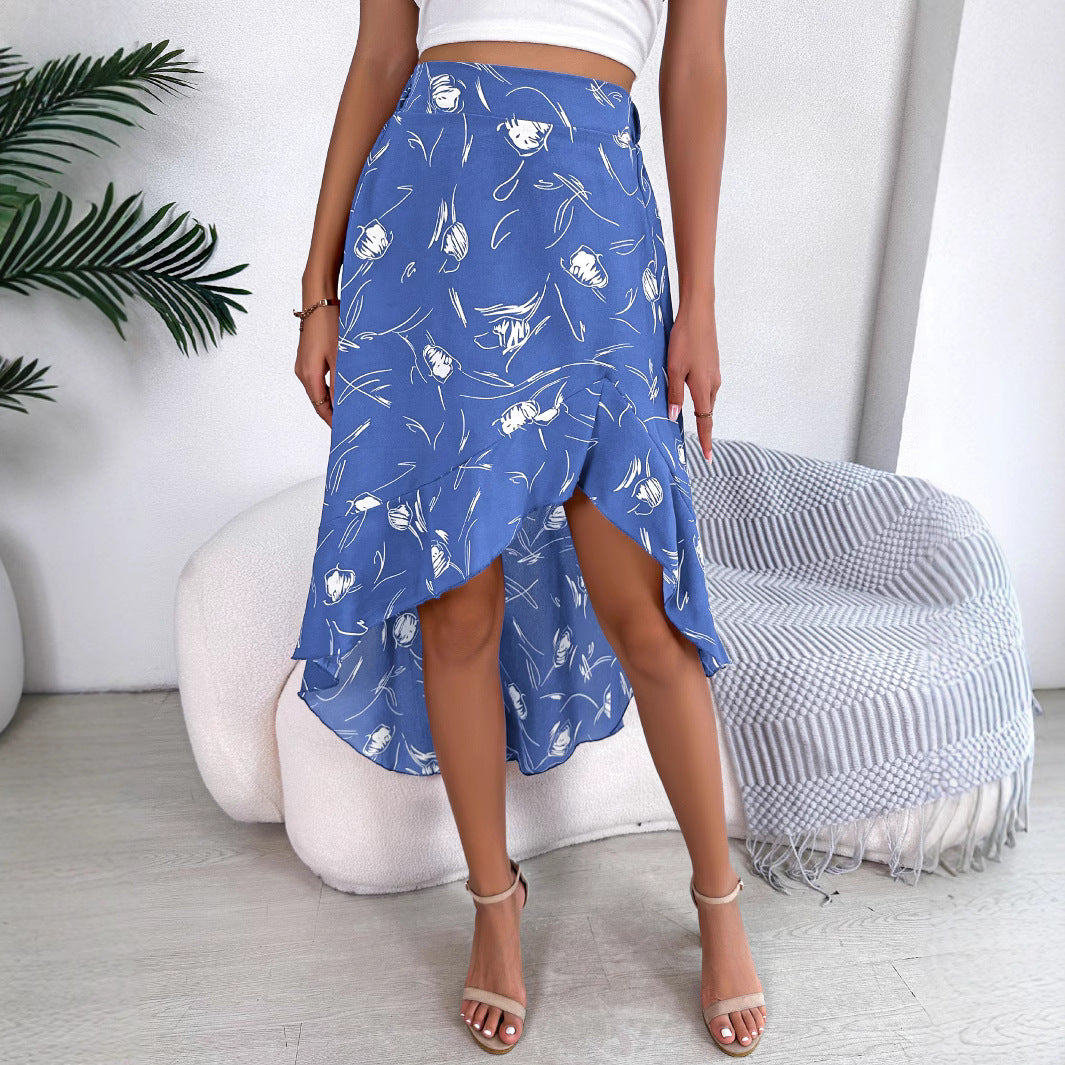 Person wearing a blue patterned skirt in a minimalistic room.
