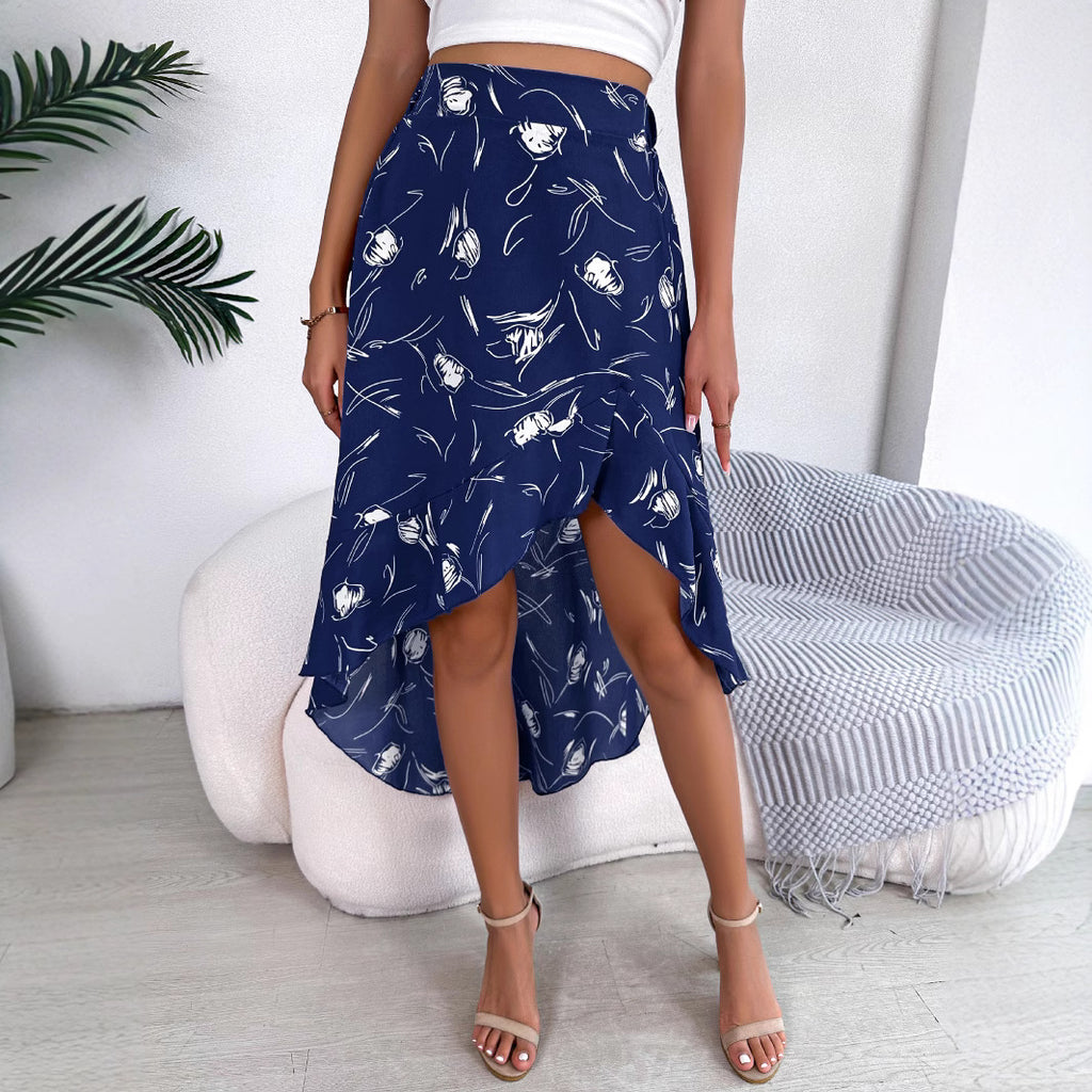 Person wearing a navy blue patterned skirt with a white background