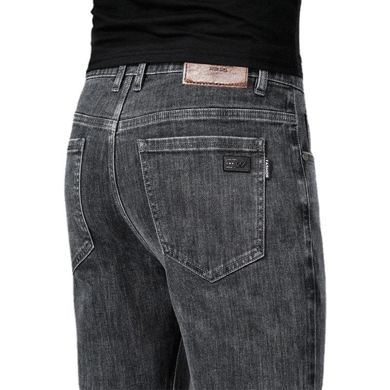Back view of gray jeans with brand label on a white background