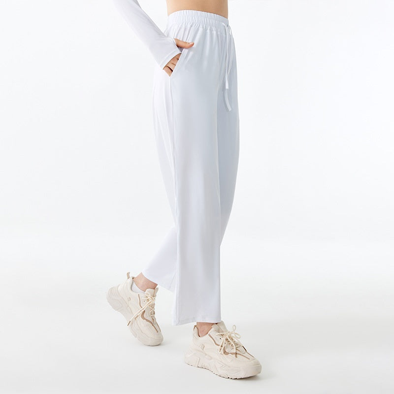White jogger pants worn by a person on a white background