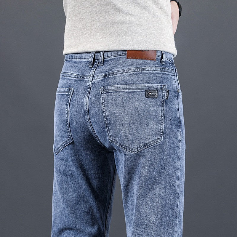 Person wearing blue jeans with a gray background
