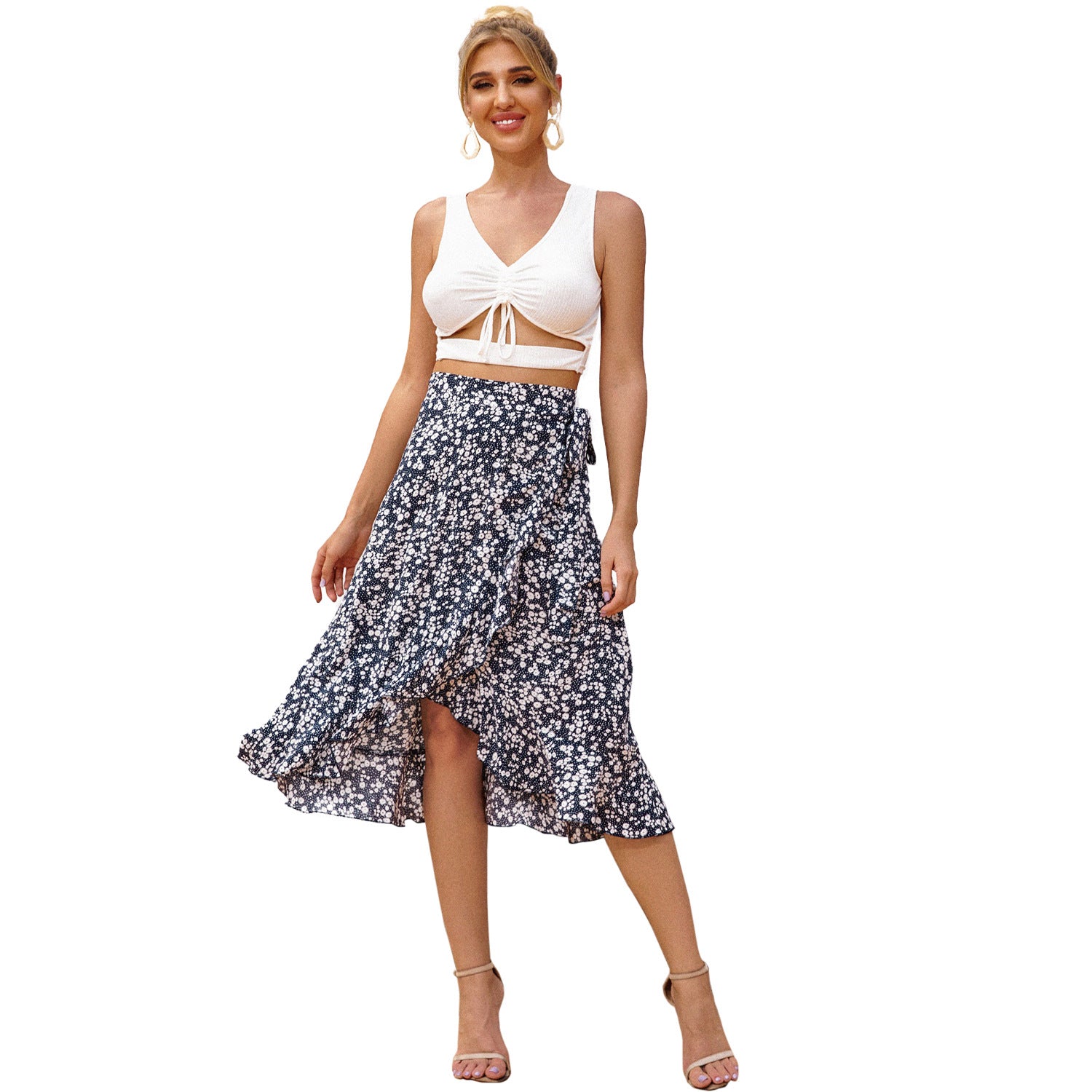 Woman wearing a white top and floral skirt on a white background