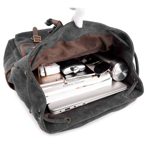Gray backpack with items like a laptop and phone inside on a white background