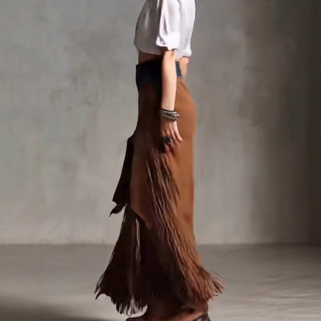 Brown fringed skirt worn by a person against a neutral background