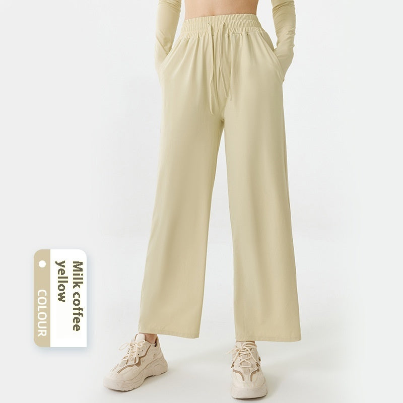 Beige wide-leg pants worn by a person on a white background with a color swatch labeled 'Milk Coffee Yellow'.