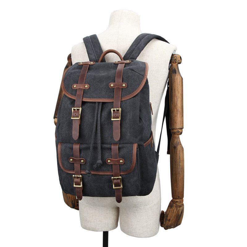 Black backpack with brown leather straps on a mannequin