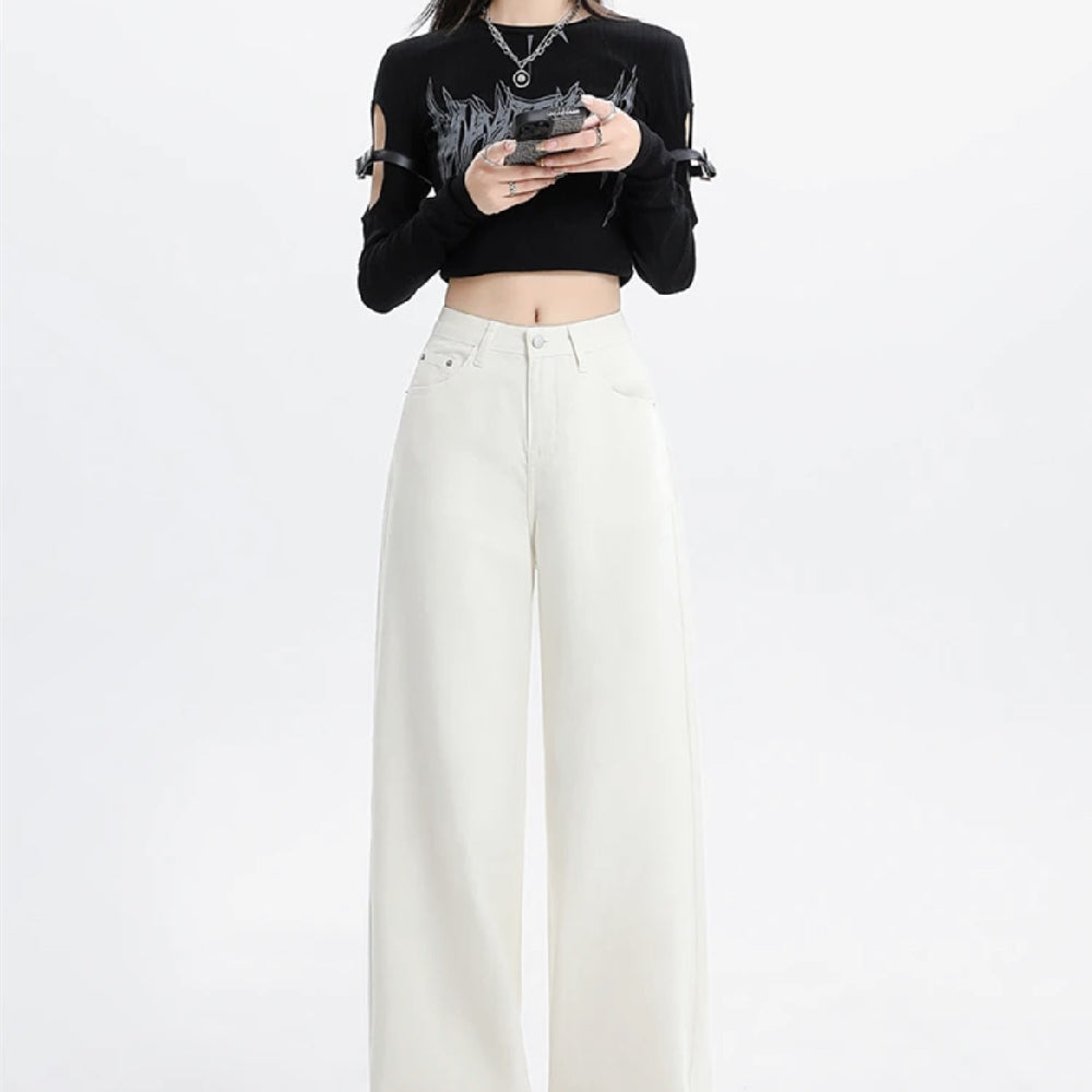 Person wearing a black crop top with cut-out shoulders and white pants on a white background
