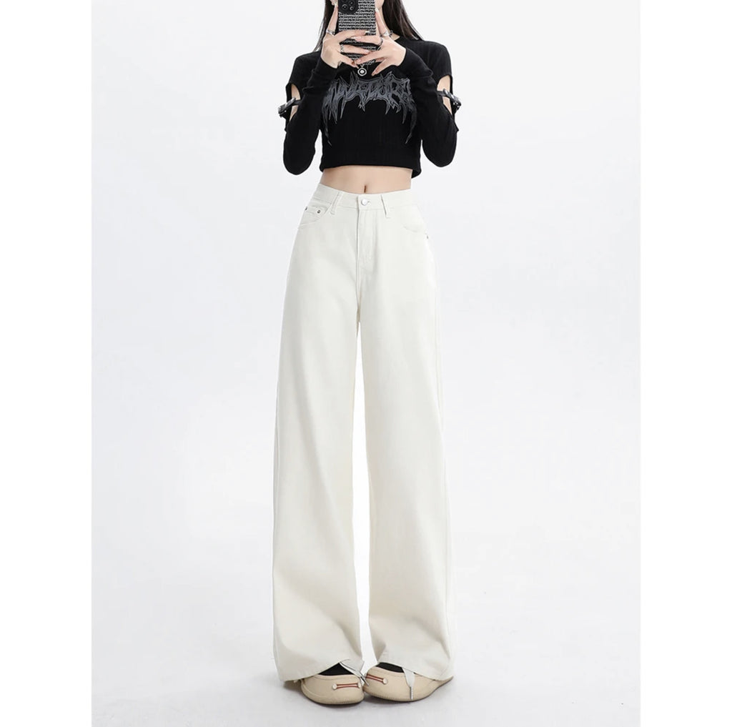 Person wearing a black cropped top and white wide-leg pants on a white background